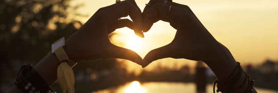 people making hands heart shape silhouette sunset