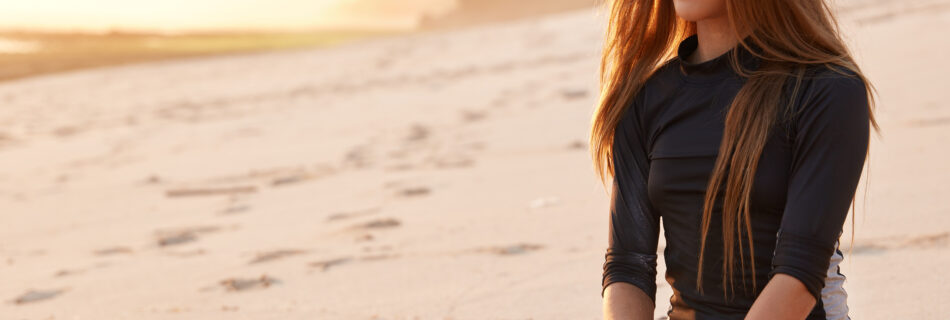 photo thoughtful good looking active surfer sits crossed legs