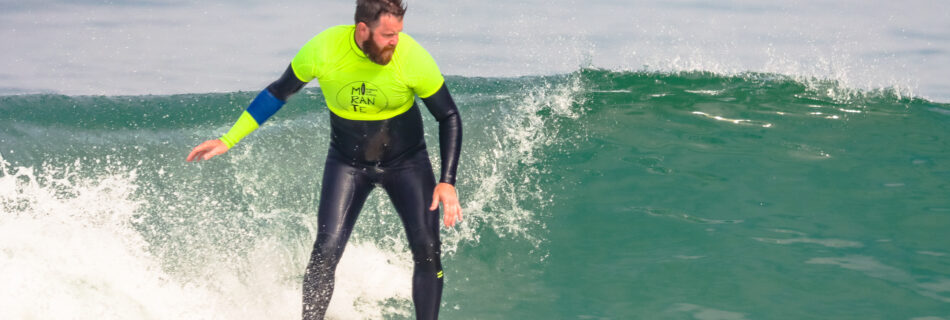 Man performing advanced surf maneuvers on clean wave