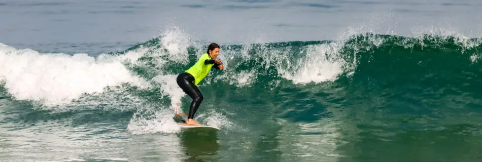 Skilled surfer reading and riding perfect wave