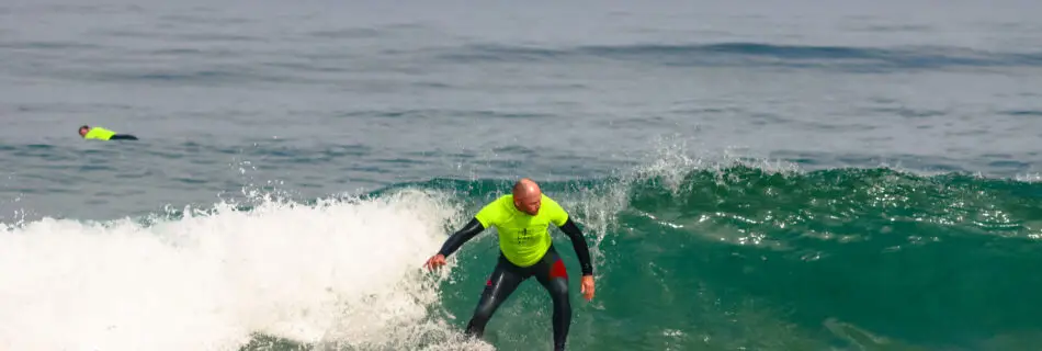 Man performing controlled surf maneuvers on wave