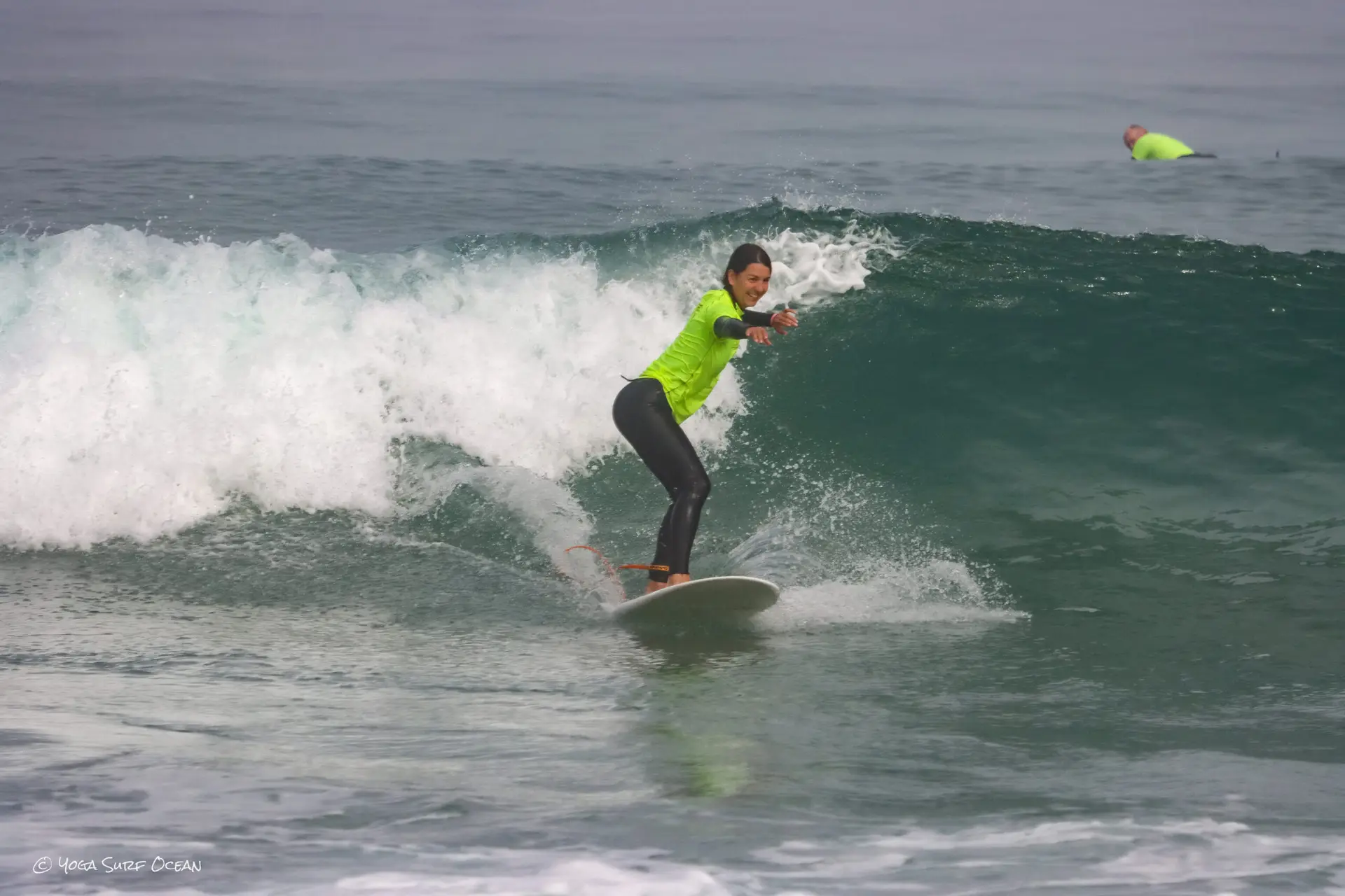 Surfer riding a green wave